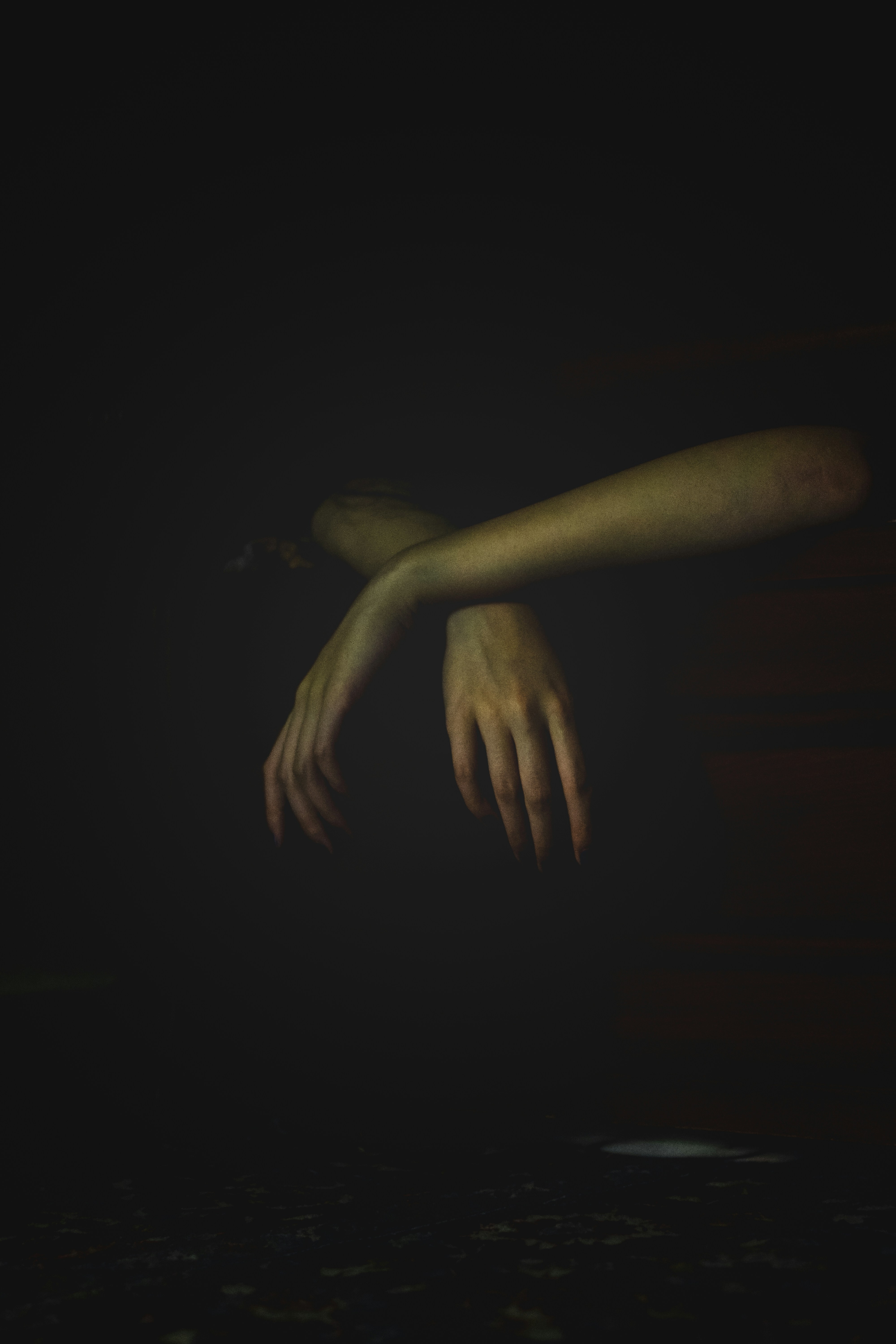 a person's hand reaching for something in the dark