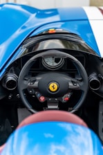 Close-up of a steering wheel and dashboard inside a high-performance sports car.