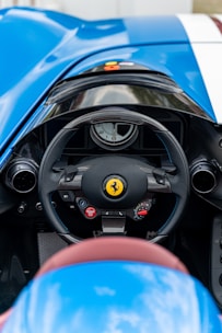 Close-up of a steering wheel and dashboard inside a high-performance sports car.