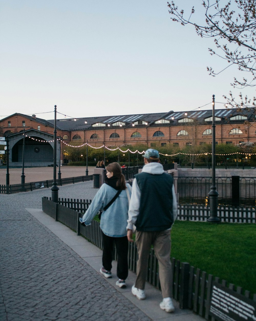 a man and a woman walking down a sidewalk