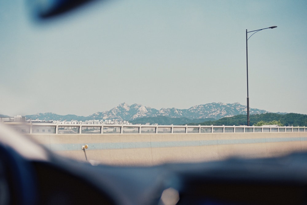 a view of a highway with mountains in the background