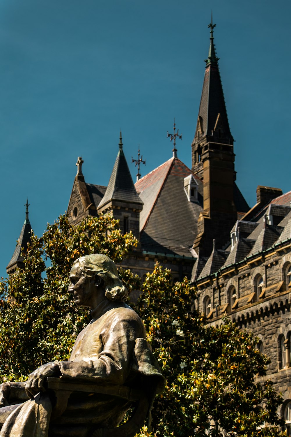 a statue of a man sitting in front of a building