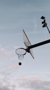A basketball mid-air shot during an intense game moment.