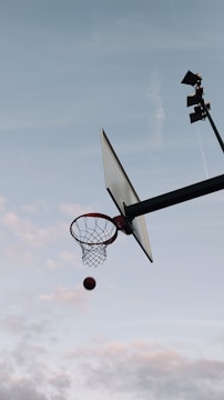 A basketball mid-air shot during an intense game moment.
