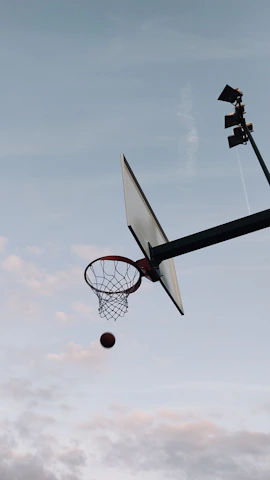 Dynamic shot of a basketball player mid-air, showcasing sports photography skills.