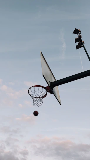 Dynamic action shot of a basketball player mid-jump, capturing the intensity of the game.