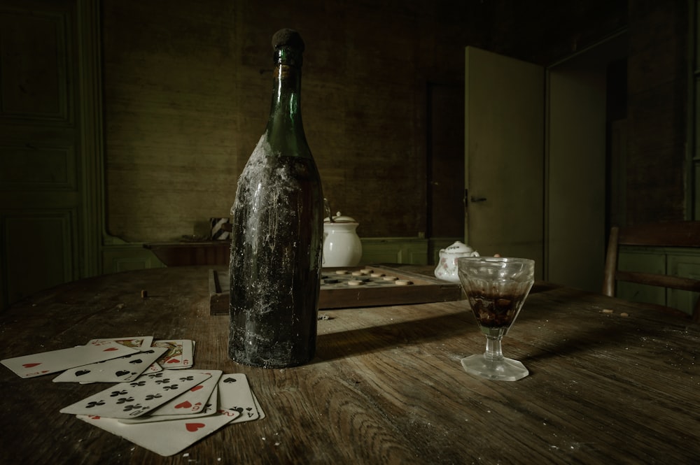 a bottle of wine sitting on top of a wooden table