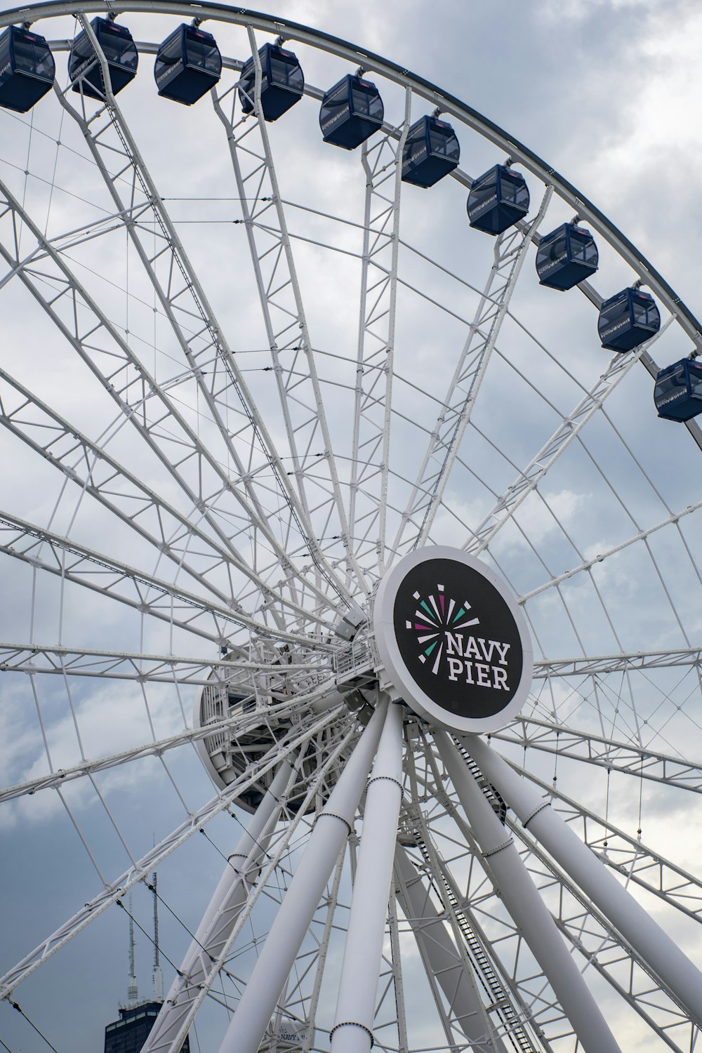 a large white ferris wheel on a cloudy day