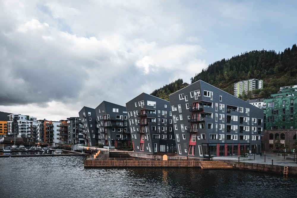 a group of buildings sitting next to a body of water