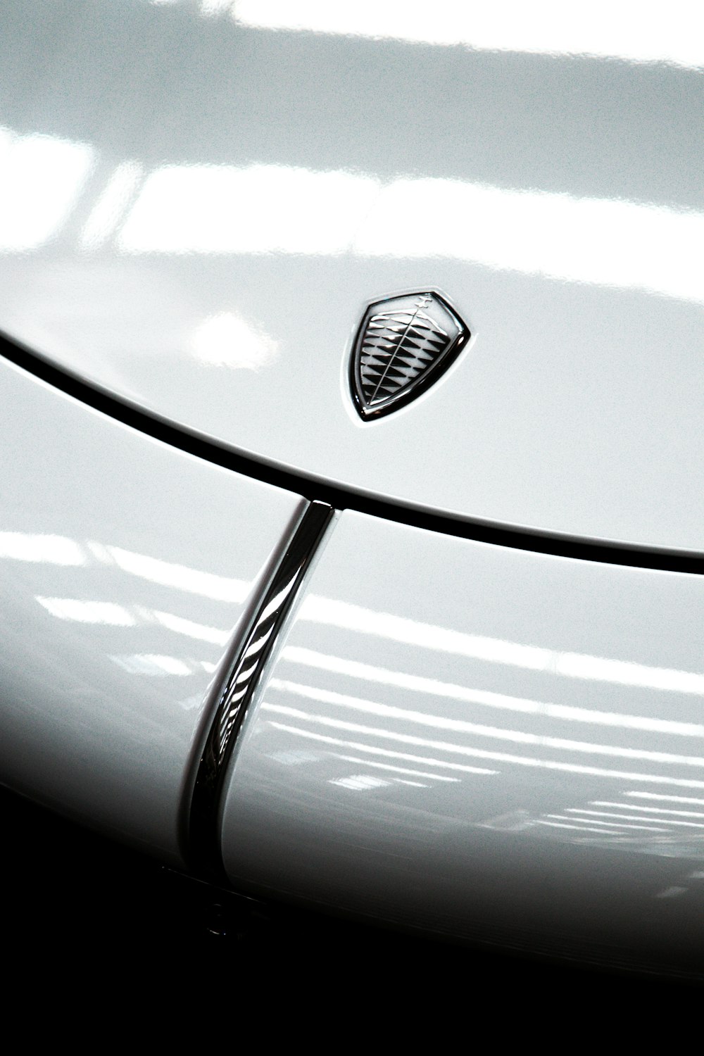 a close up of a white car with a black background