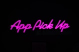Neon pink text displaying 'App Pick Up' against a dark background.