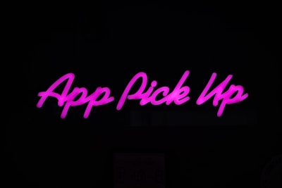 Neon pink text displaying 'App Pick Up' against a dark background.