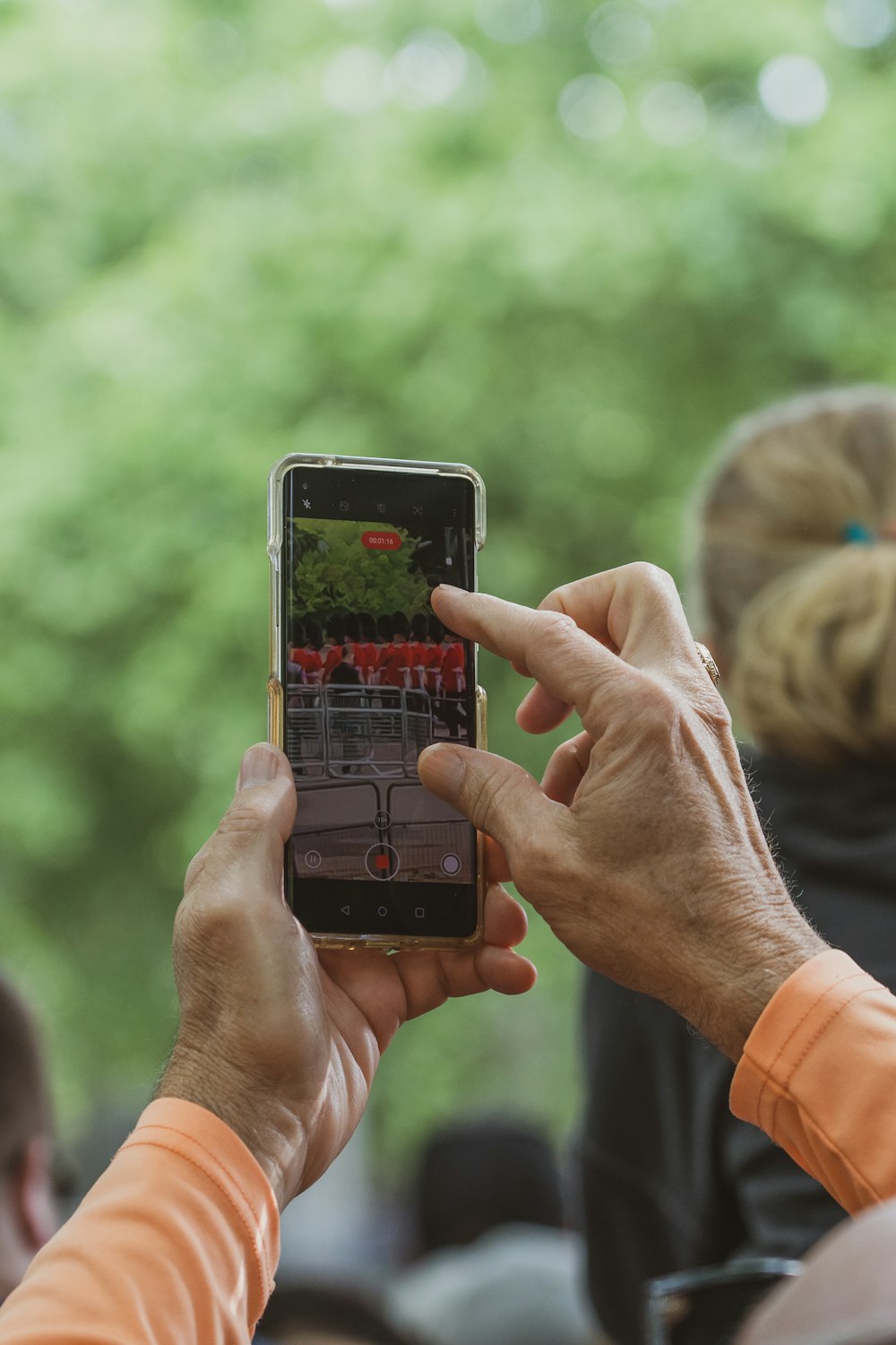 a person holding a cell phone up to take a picture