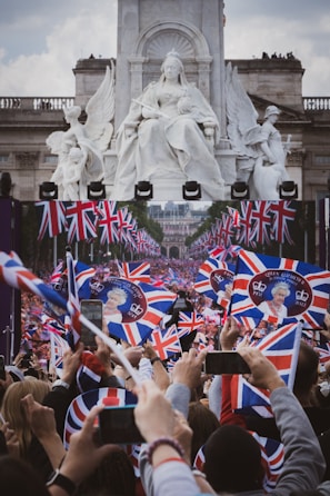 A group of Riverside UK fans proudly waving British flags at a local park gathering.