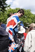 a man in a union jack shirt is standing in front of a crowd