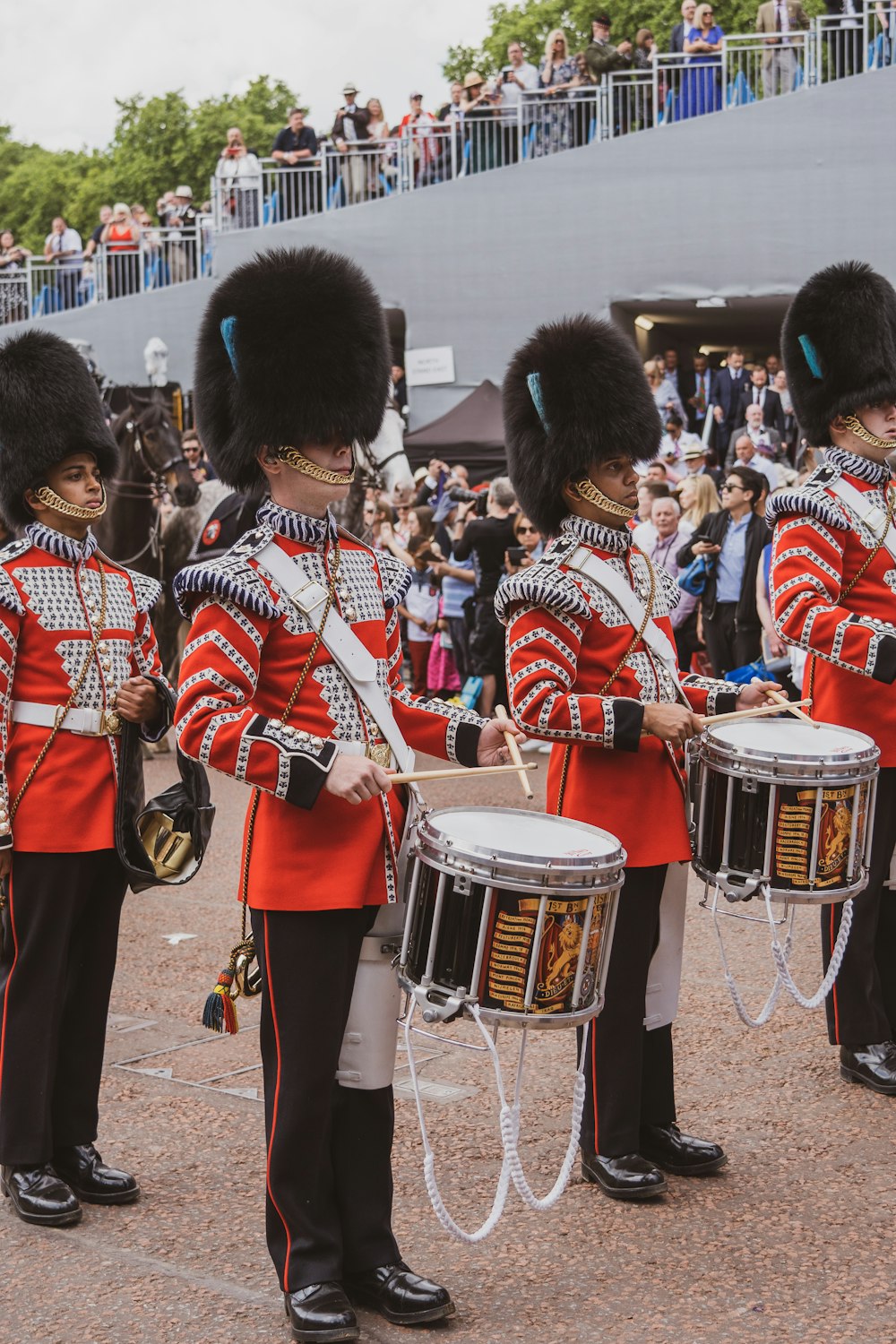 a group of men in uniform playing drums