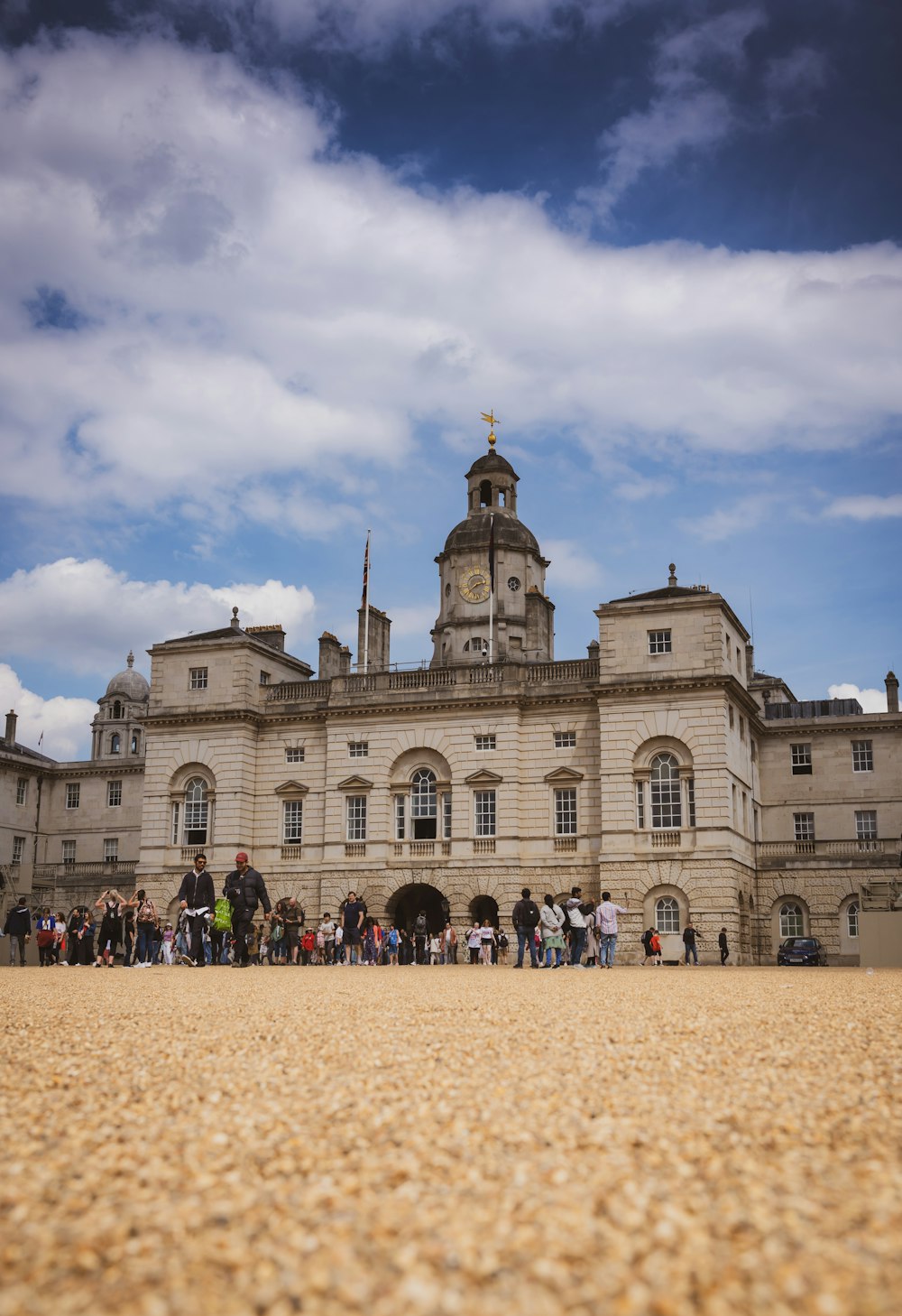 a group of people standing in front of a large building