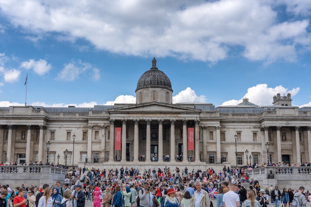 a large group of people standing in front of a building