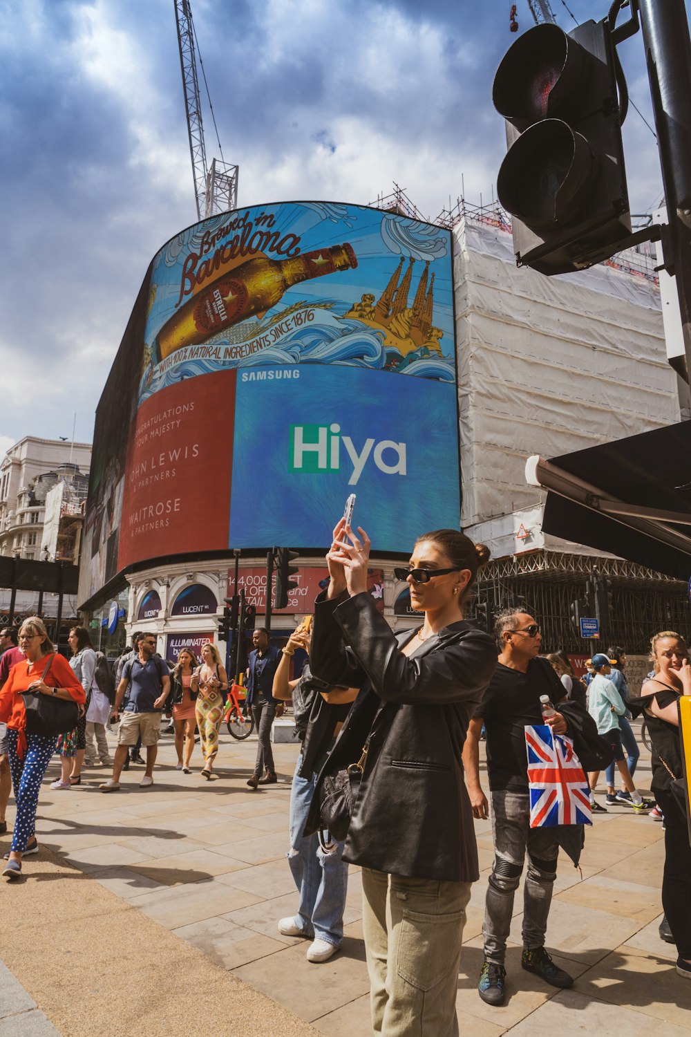 a woman taking a picture of a billboard