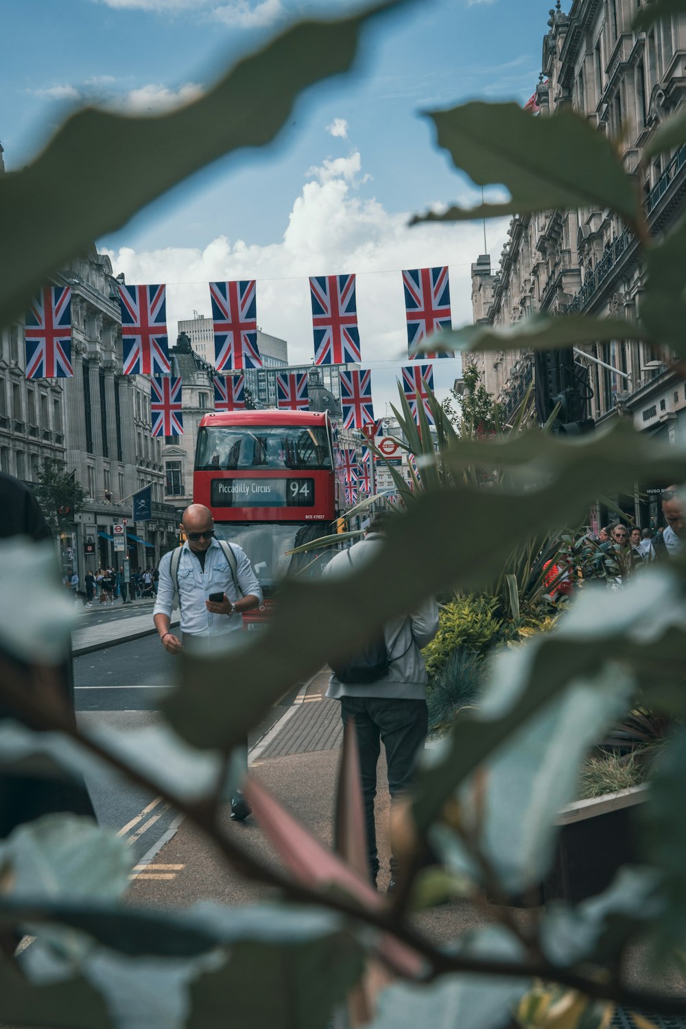 a red double decker bus driving down a street