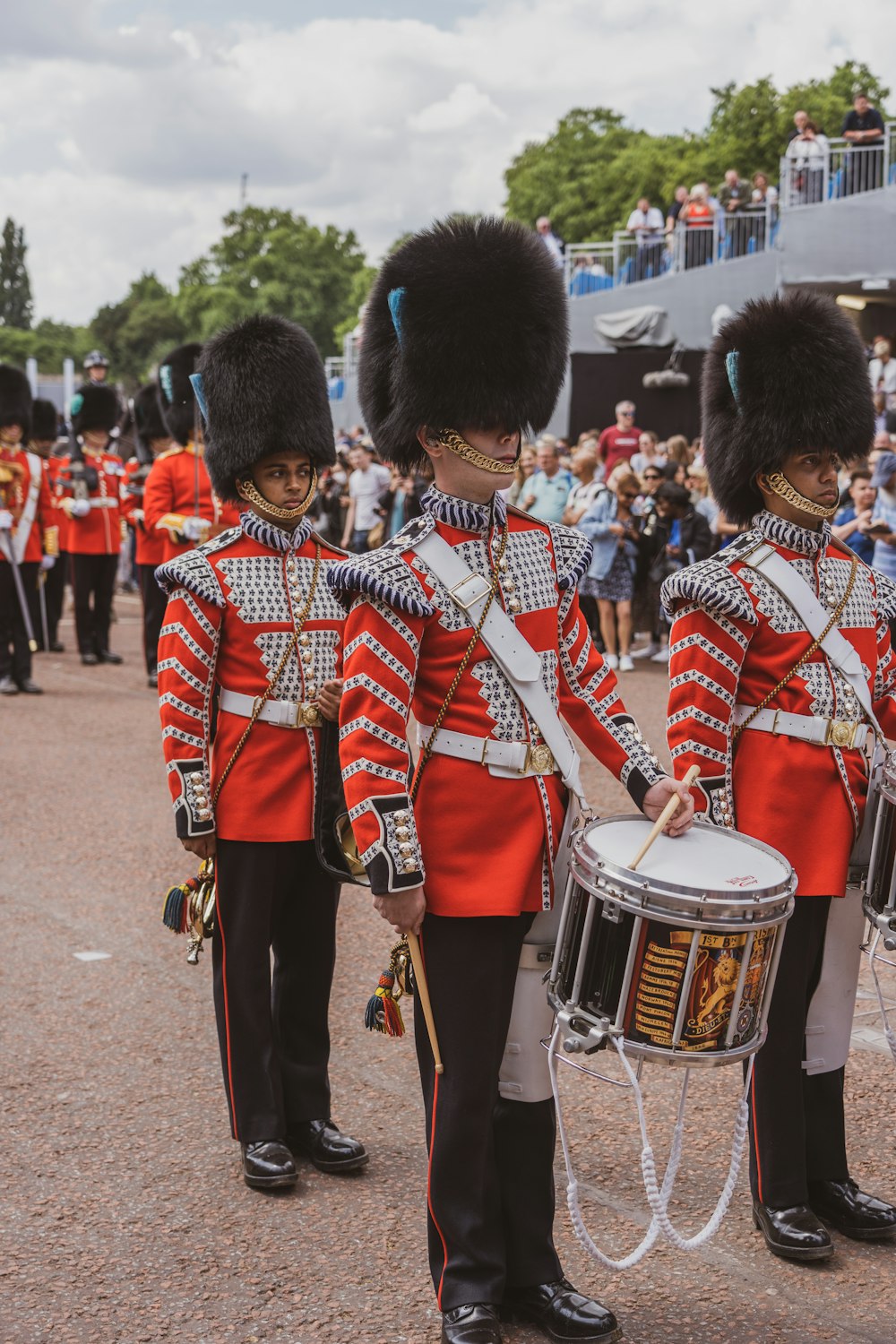 a group of men in uniform playing drums