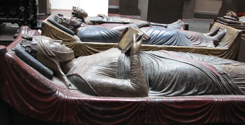 a large statue of a woman laying on a bed