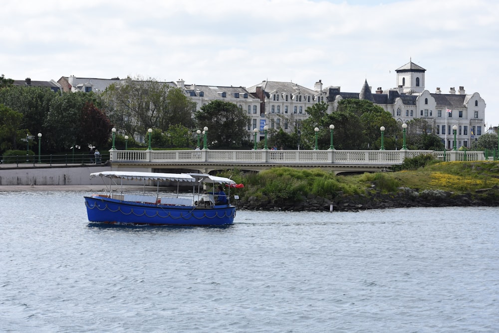 a blue and white boat in a body of water