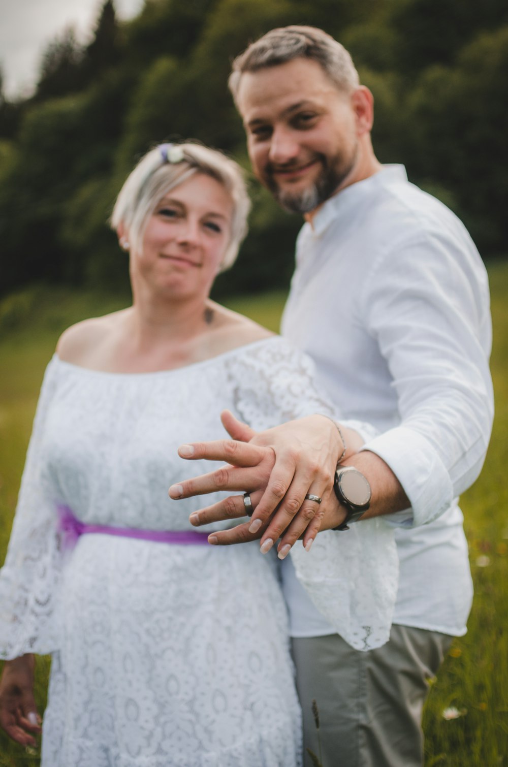 a man and a woman standing in a field