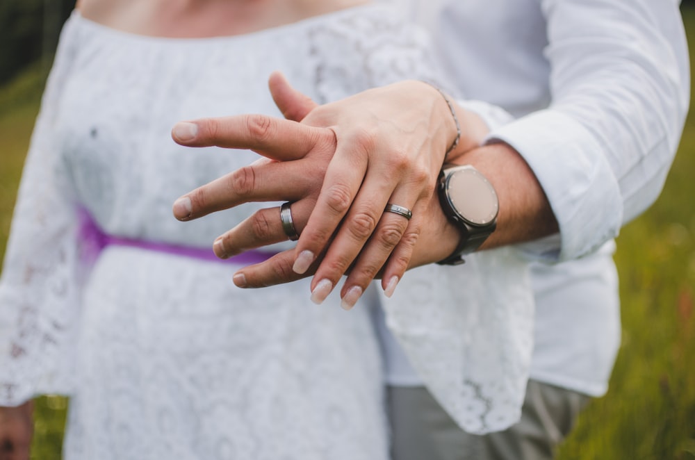 a close up of a person holding another person's hand