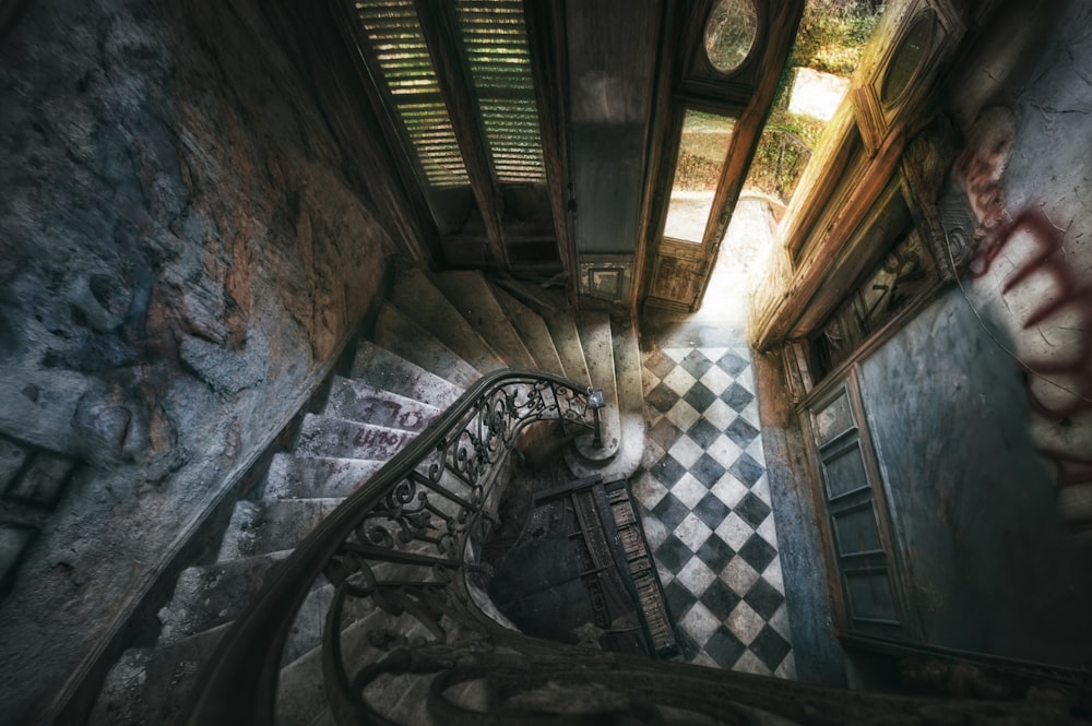 a staircase in an abandoned building with graffiti on the walls