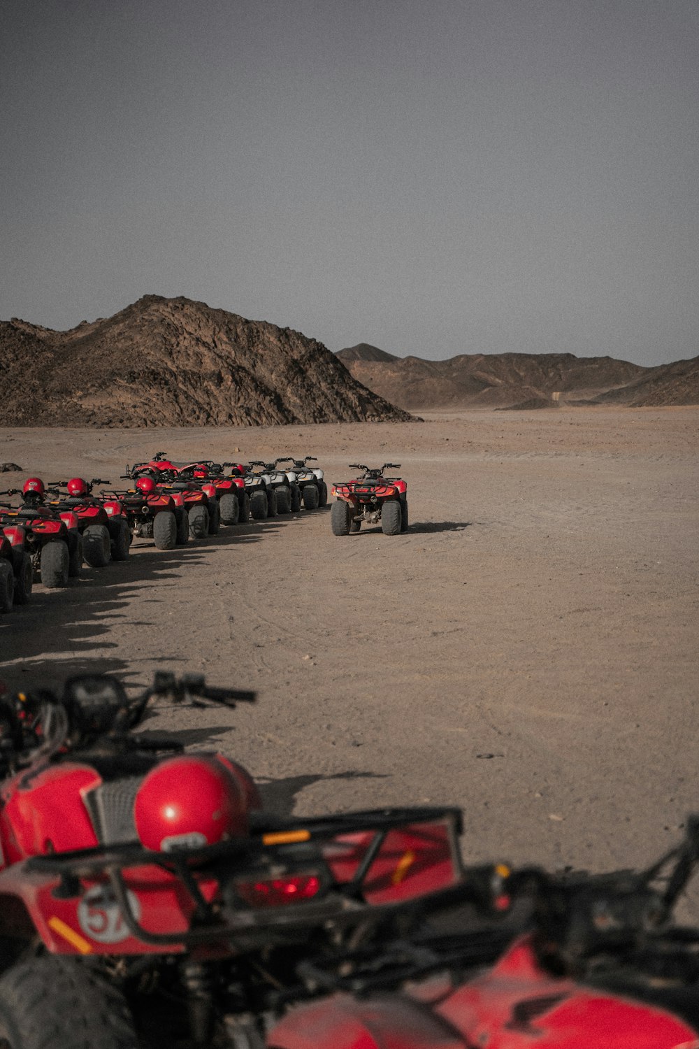 a group of four wheelers parked in the desert