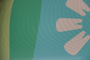 A close-up of a surface with a pattern of small, evenly spaced black dots overlaid on a background featuring shades of green and beige. On the right, there are stylized, abstract shapes resembling leaves or petals in a lighter beige color.