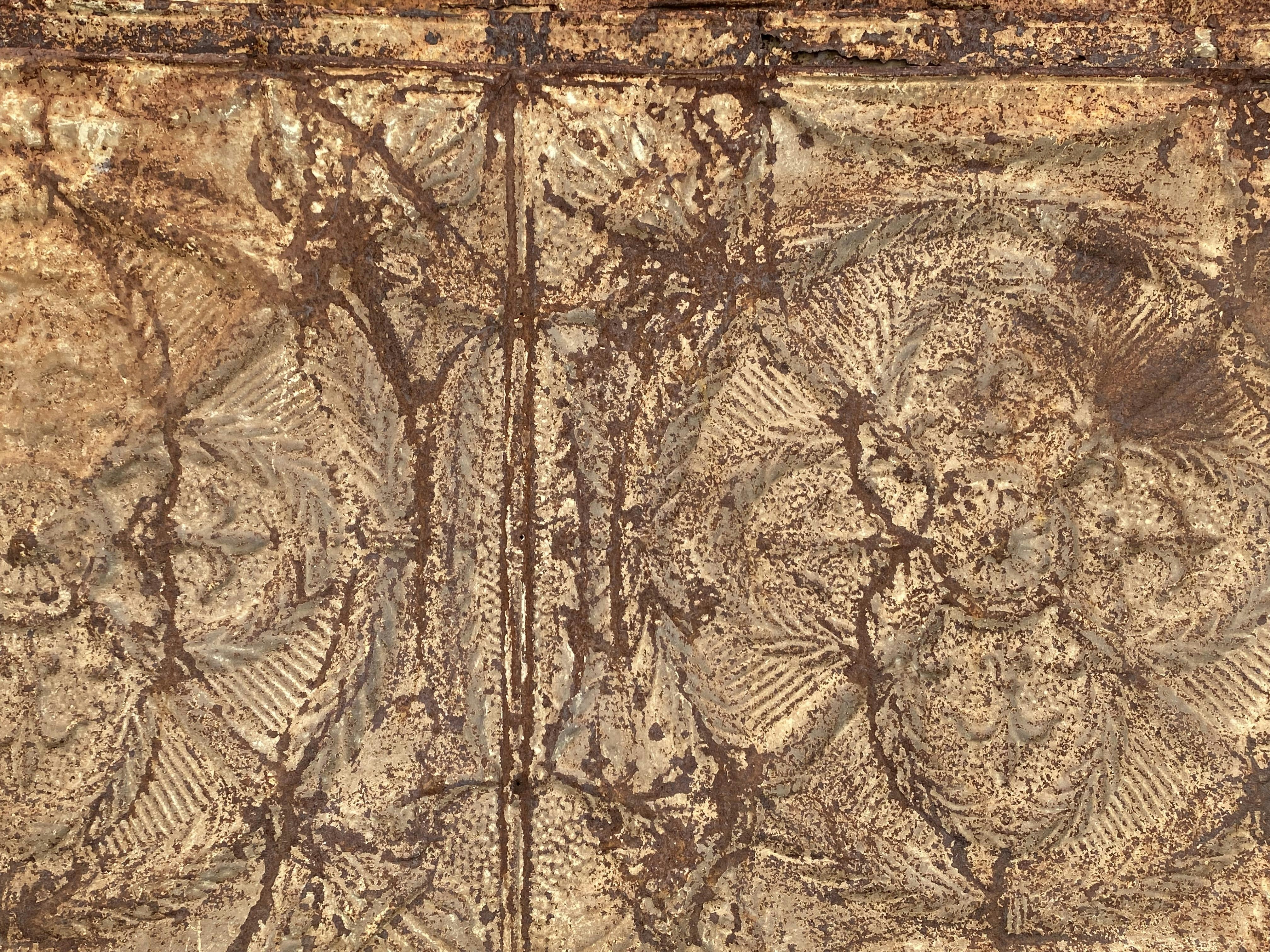 Mixed media artwork combining rusted metal textures with delicate floral watercolor elements