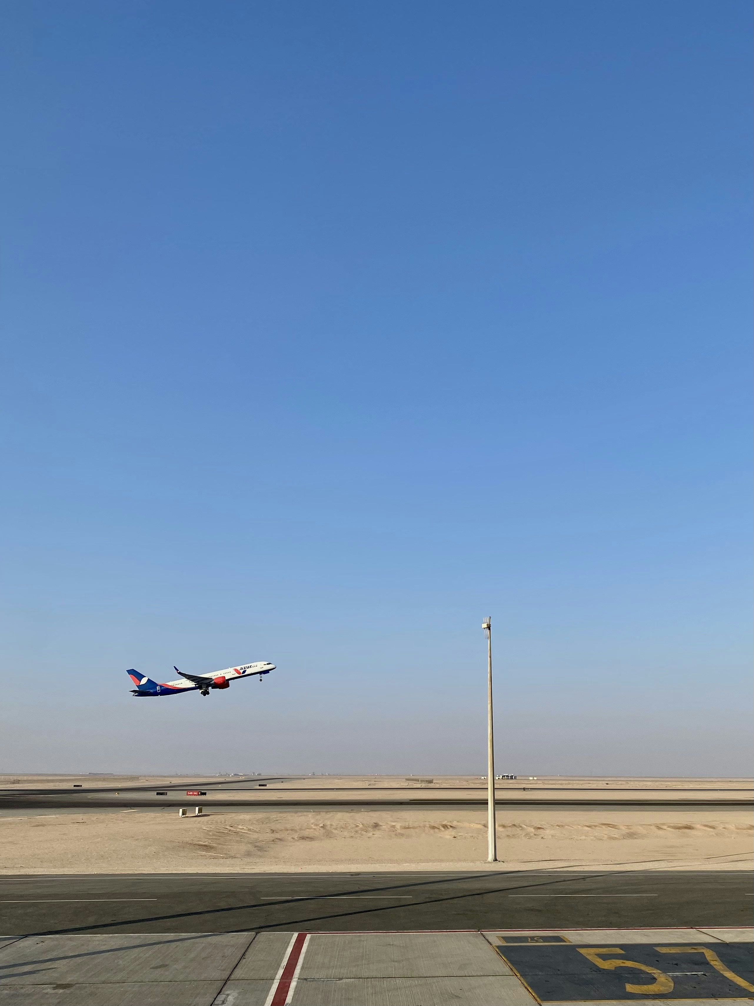 a large jetliner flying through a blue sky