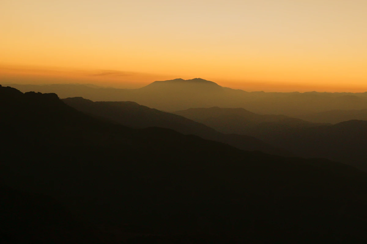 Layered mountain ridges at golden sunset