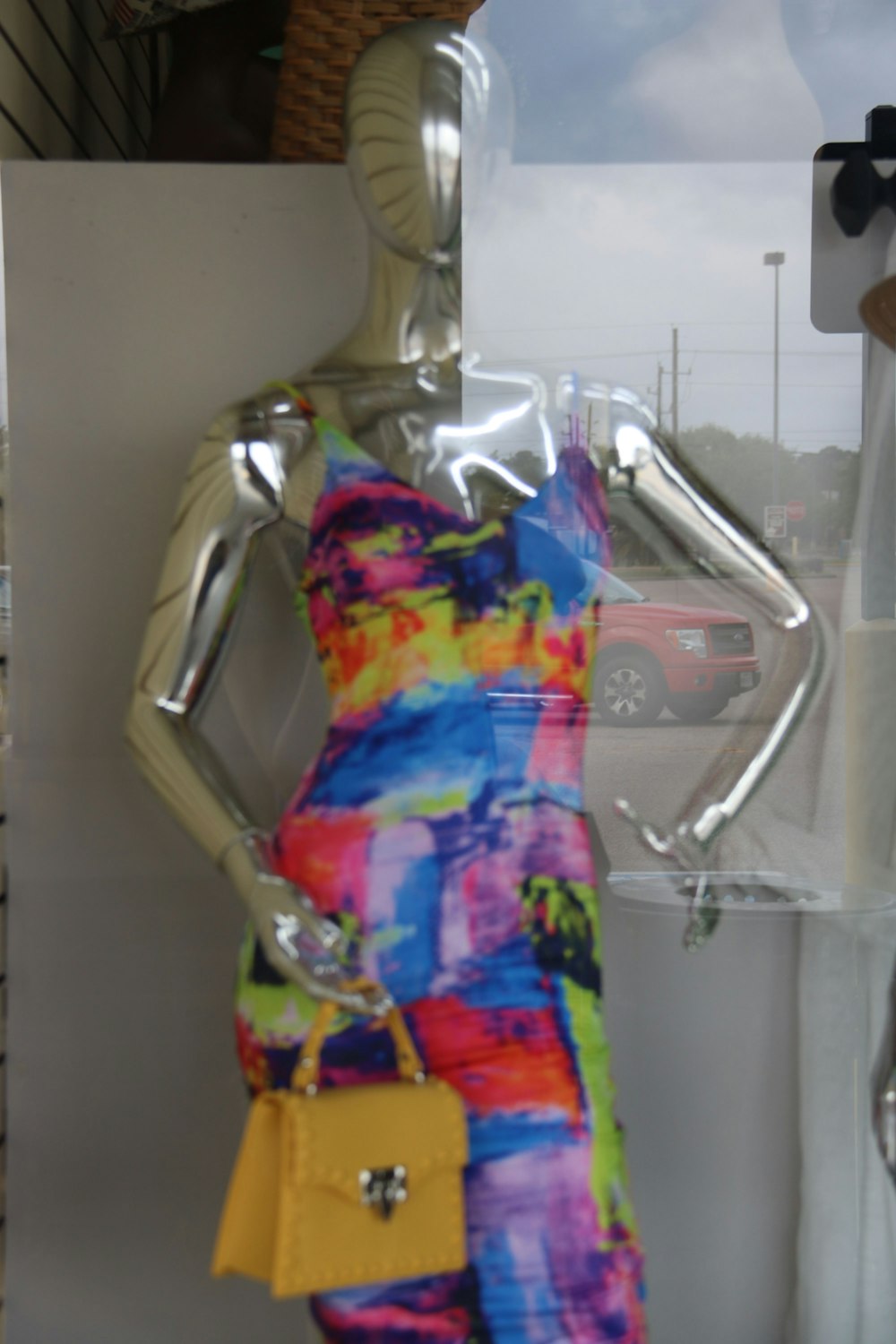 a mannequin dressed in a multicolored dress