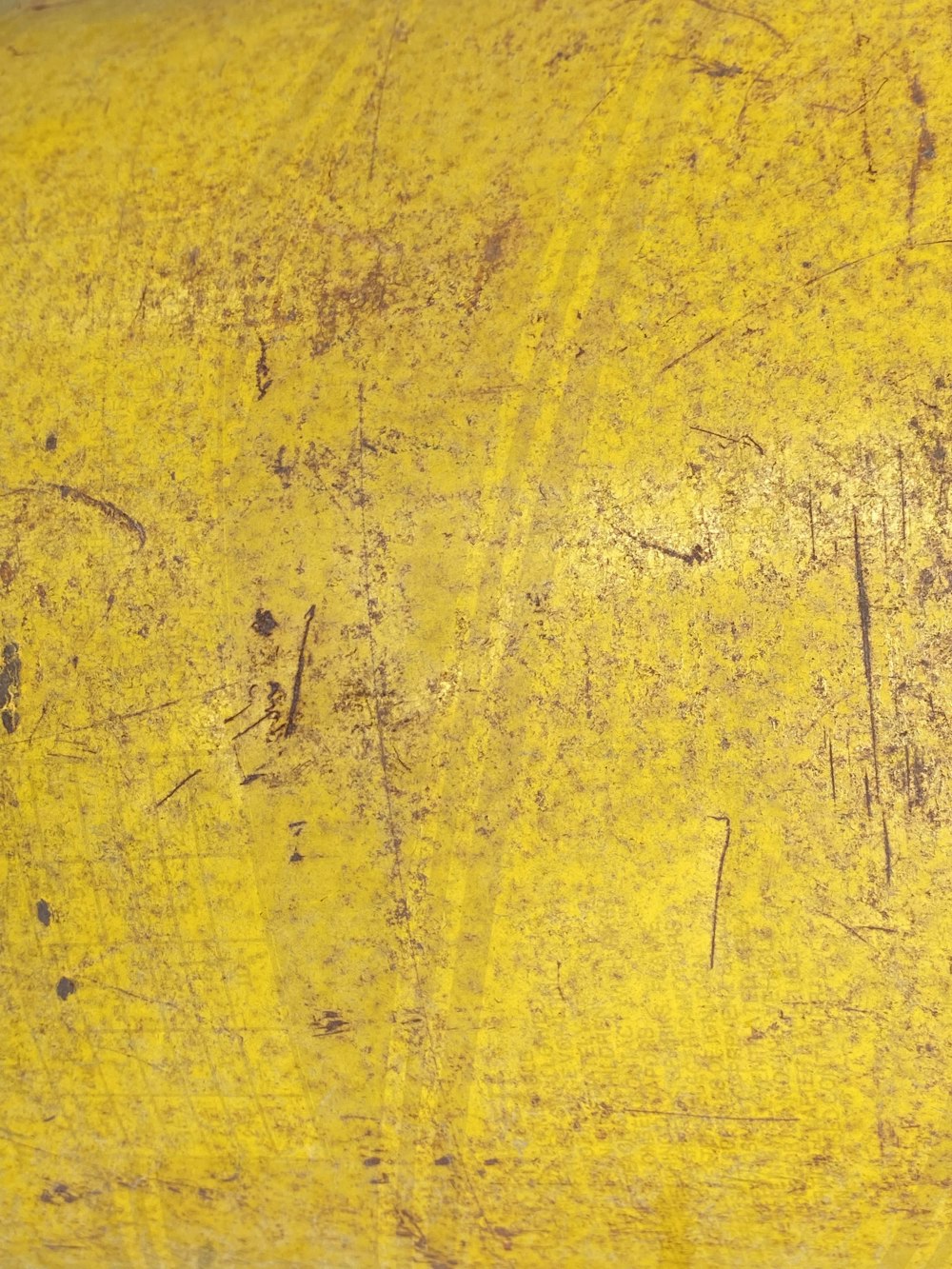 a close up of a yellow object with writing on it