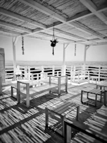 Outdoor terrace with wooden benches and views of Medina del Campo's historic rooftops.