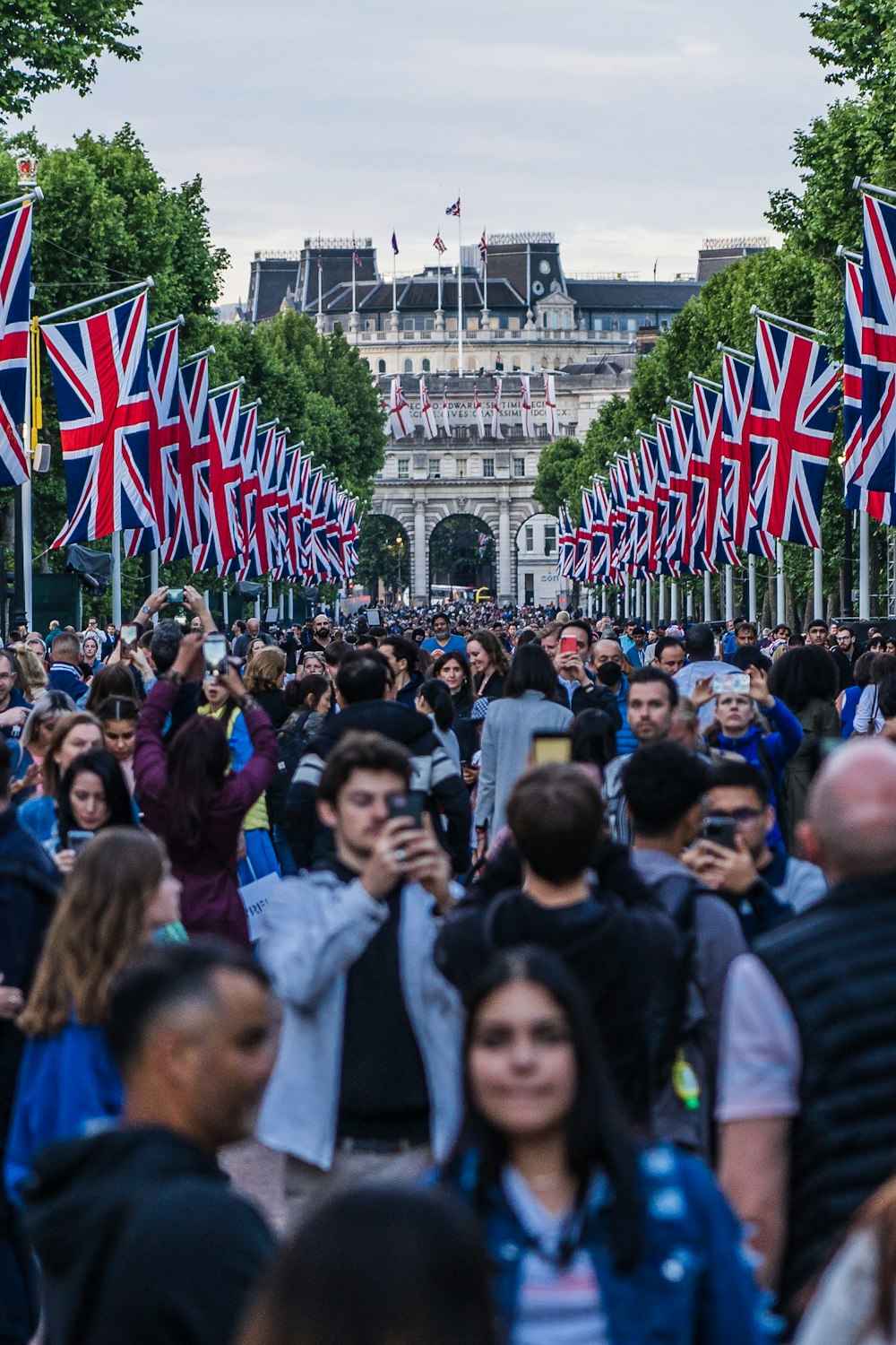 a large crowd of people walking down a street