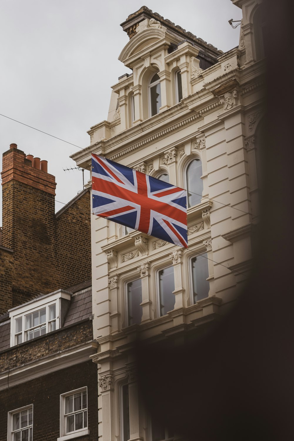 a british flag flying in front of a building