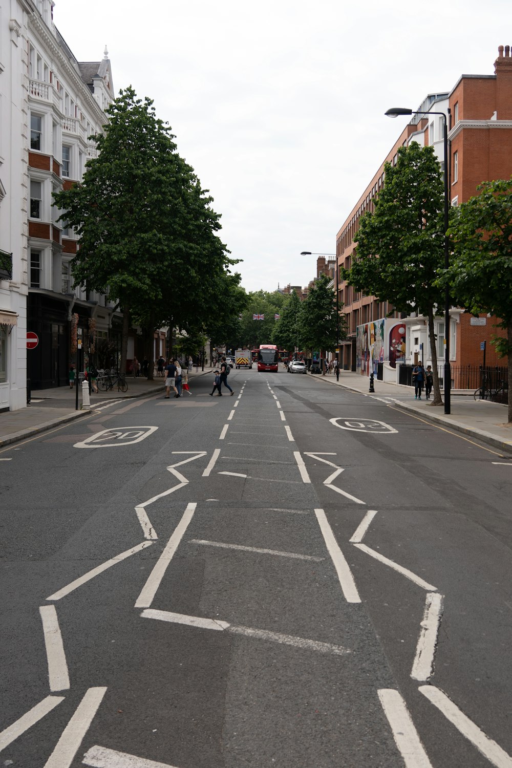 a city street with white arrows painted on it