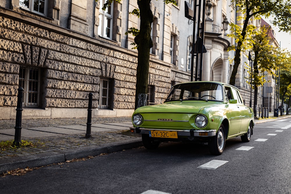 a green car parked on the side of the road