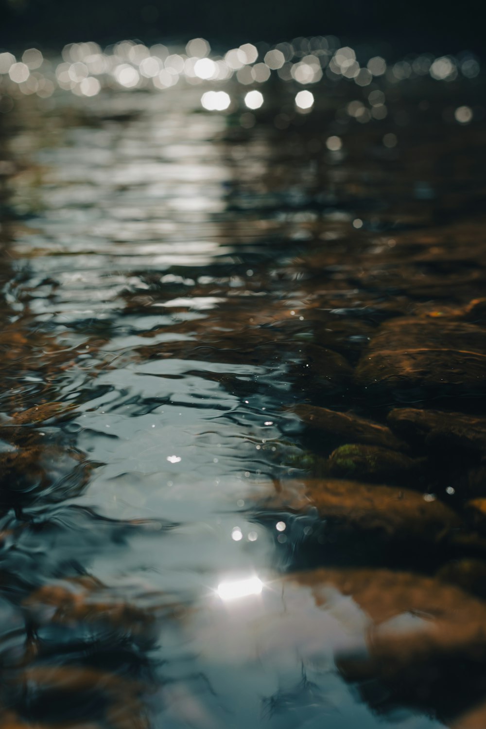 a close up of a body of water with rocks in it