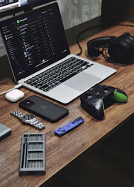 a laptop computer sitting on top of a wooden desk