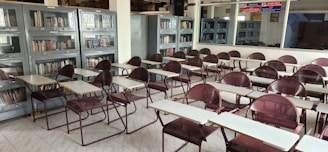 a room filled with lots of desks and chairs
