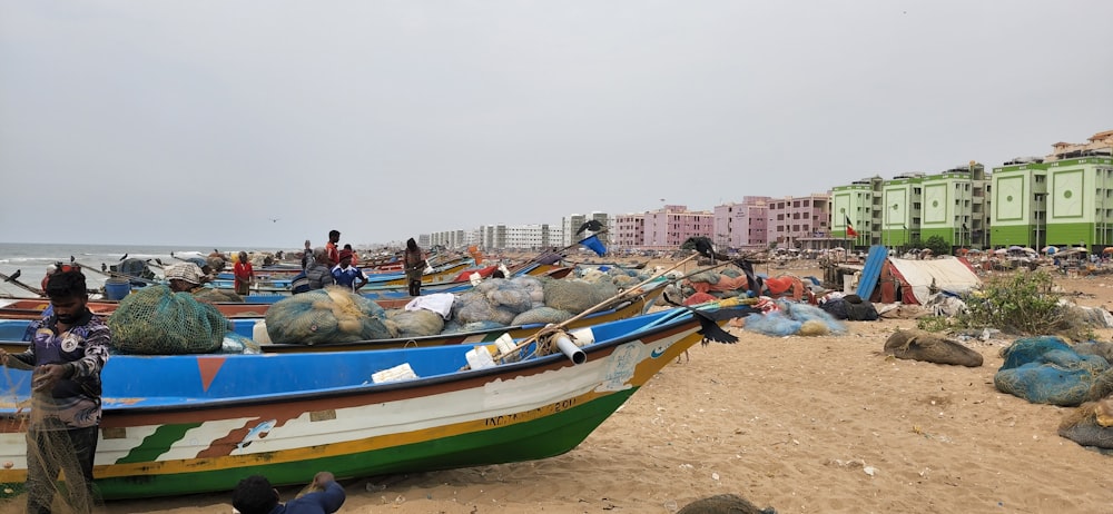 a group of boats sitting on top of a sandy beach