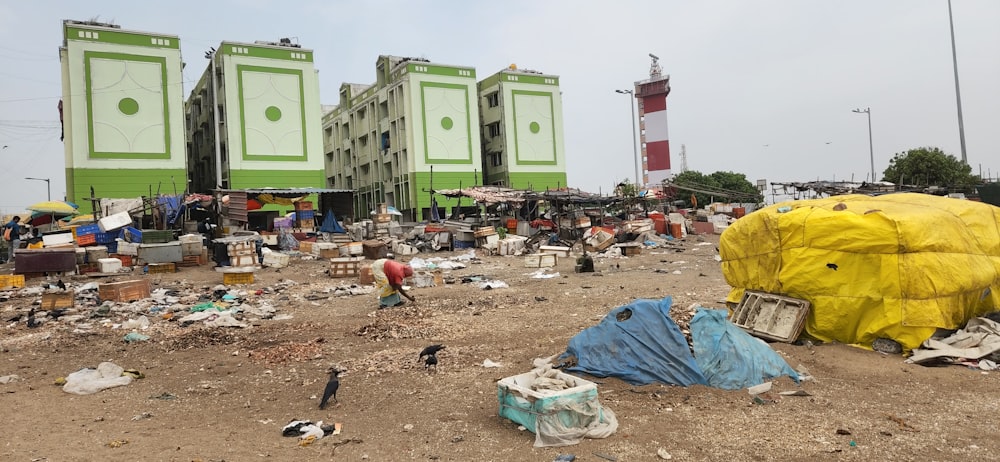 a group of people standing around a pile of trash