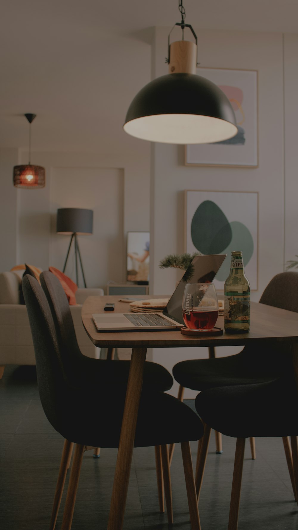 a dining room table with a laptop on it