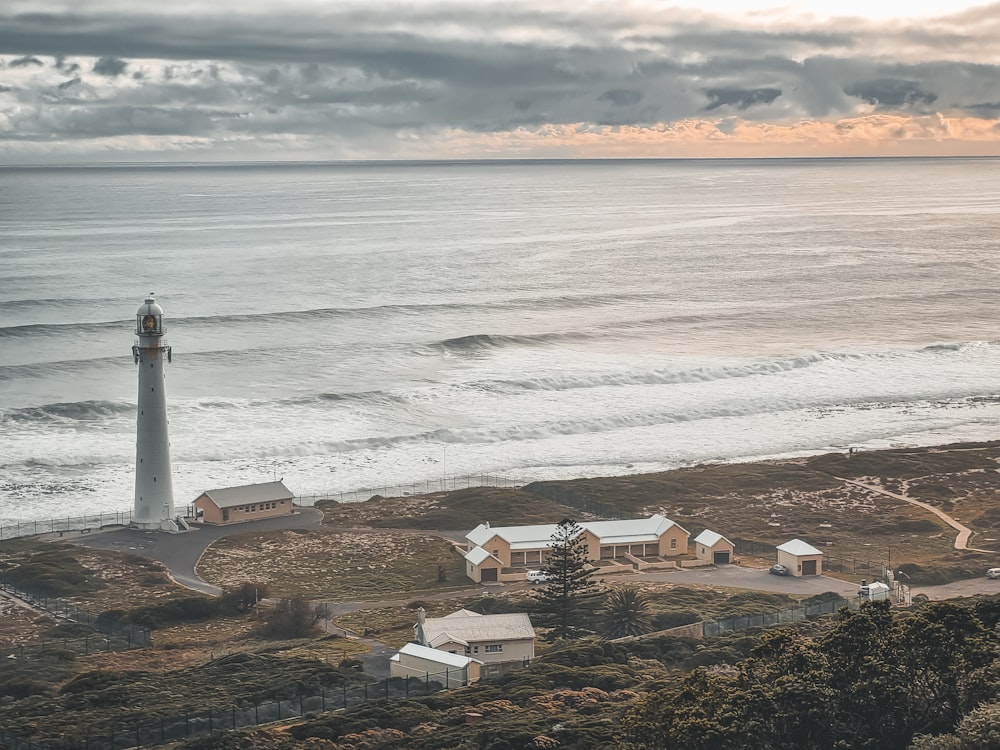 a light house on a hill near the ocean