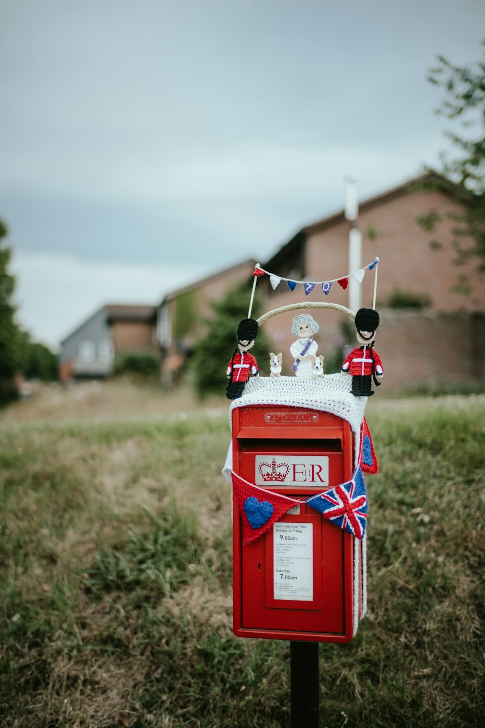 a red mailbox with a flag on top of it